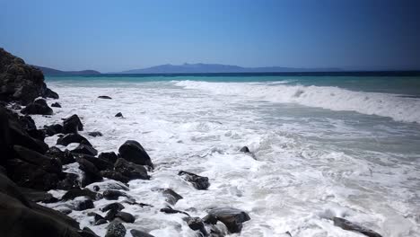 wavy sea painted in shades of azure and white, embracing the rocky beach on the mediterranean coastline, panoramic ionian beauty