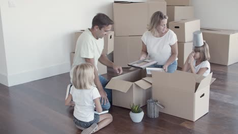 parents and two girls having fun while packing things