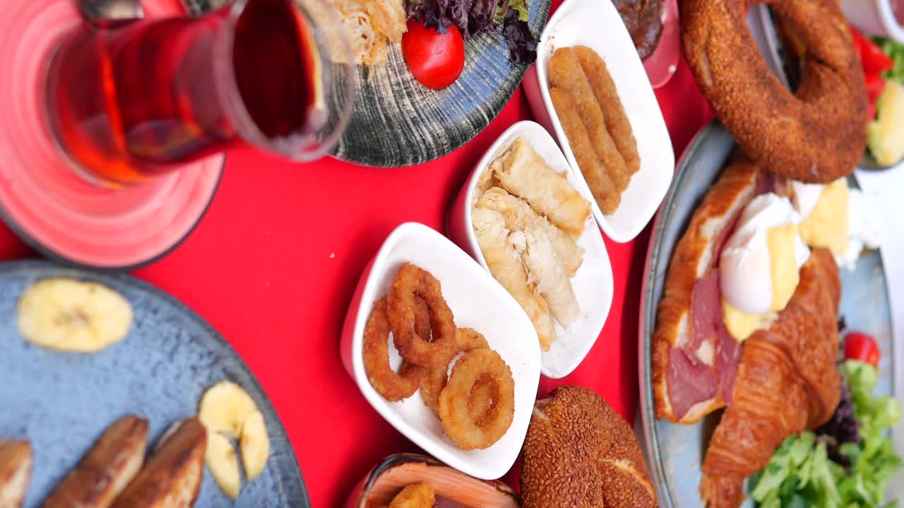 Delicious Turkish Breakfast Spread with Simit, Croissant, and Tea
