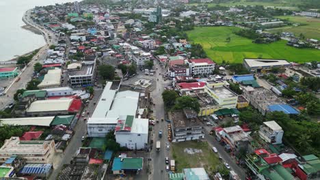 overhead aerial dolly of quaint provincial town with old buildings and busy streets in catanduanes, philippines