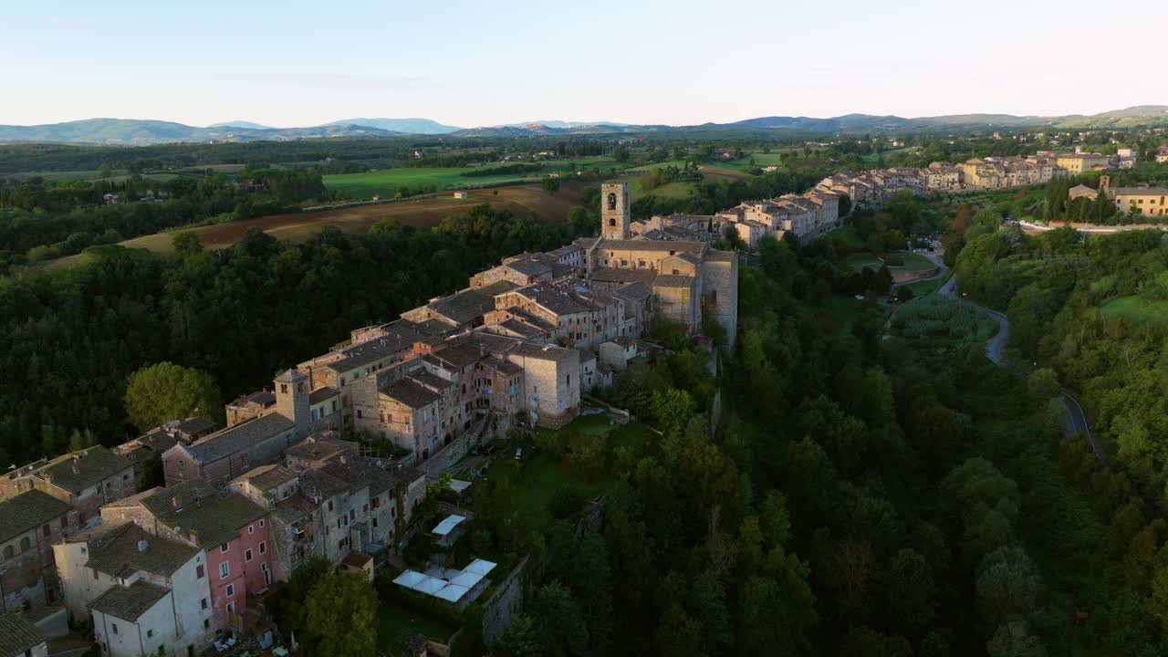 Colle di Val d'Elsa Town Over Senese Chianti Hills At Sunrise In Tuscany, Italy. Aerial Drone Shot