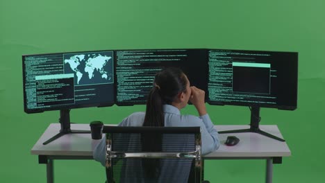 programmer working on multiple monitors