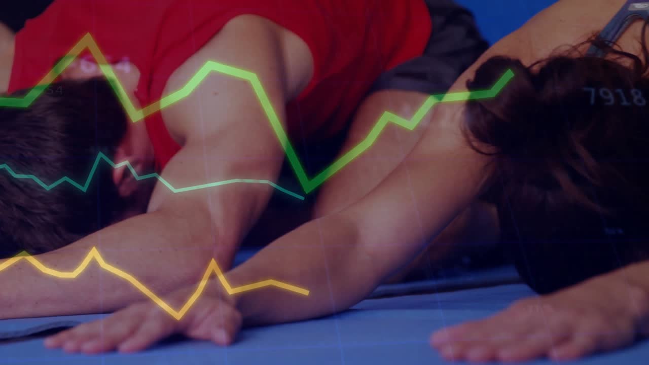 Fitness class posing, cam moving to red-tank man, charts tracking stats across arms on blue mats