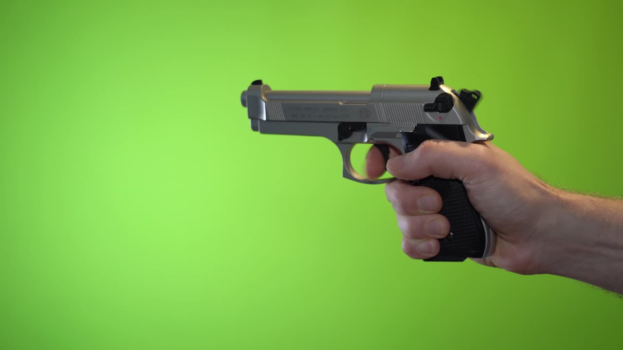 Green screen chroma key hand loading and firing blanks Beretta pistol with no real fire