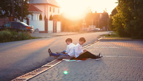 students-sit-on-street-sidewalk-surrounded-by-books