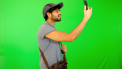 indian tourist taking selife on road with green background - green screen