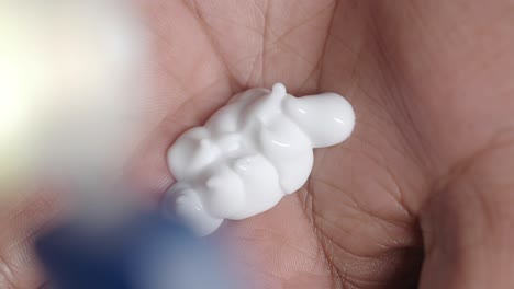 white cream in hand