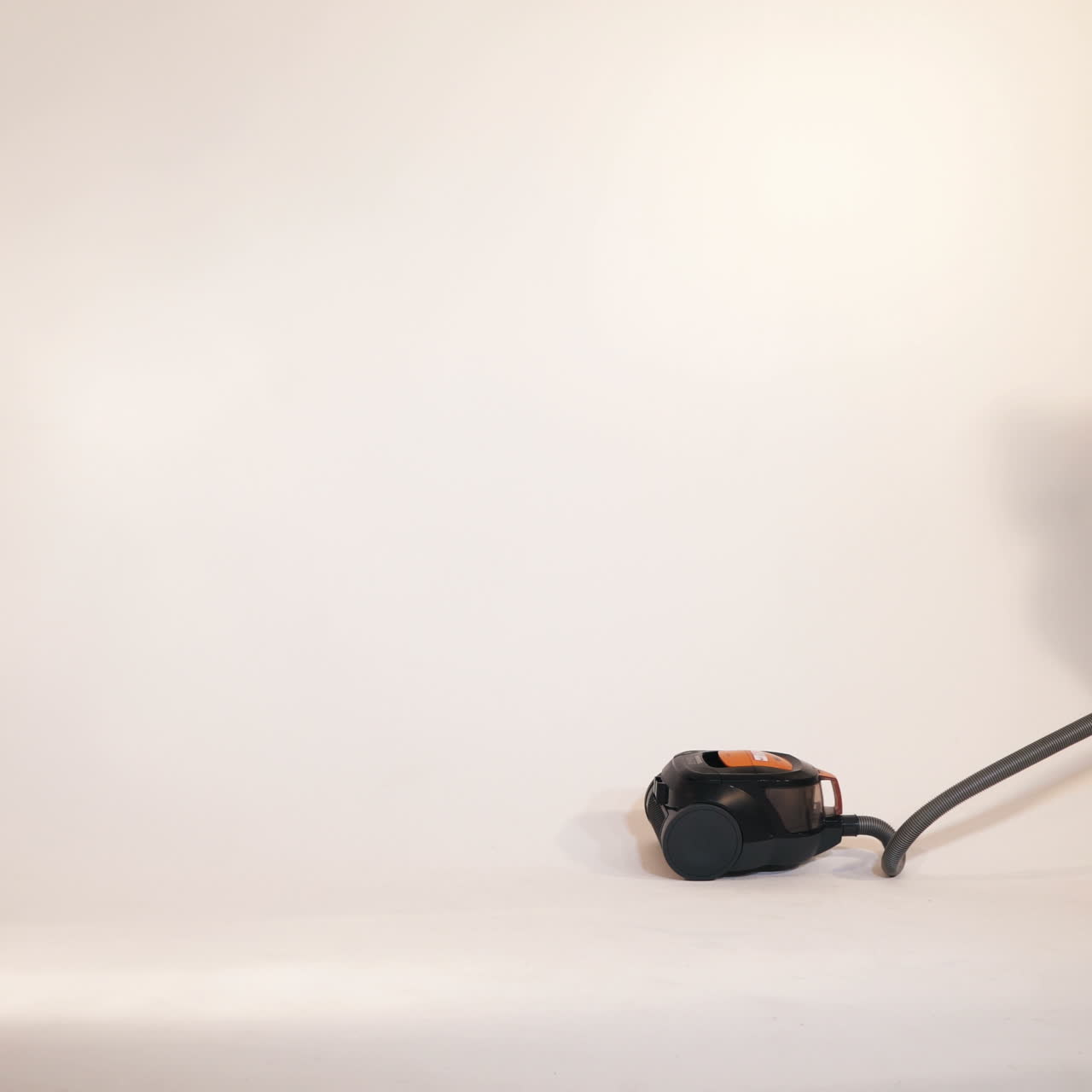 Little children play with a vacuum cleaner. Emotions of the child. Studio shooting of children.