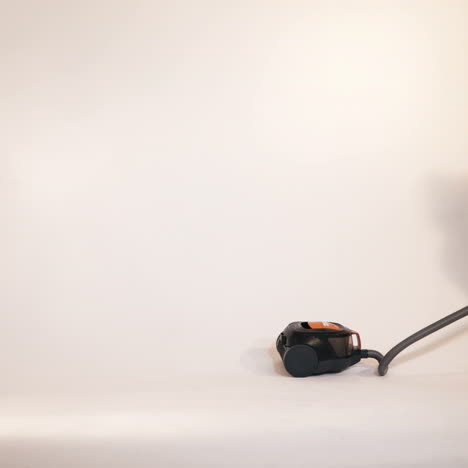 little children play with a vacuum cleaner. emotions of the child. studio shooting of children.