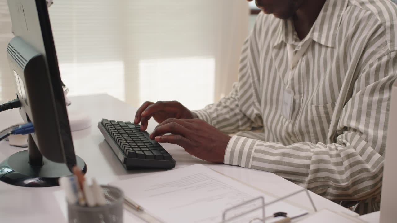 Black Bank Manager Taking Document out of Folder