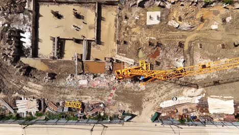 aerial view of a busy construction site with crane and workers