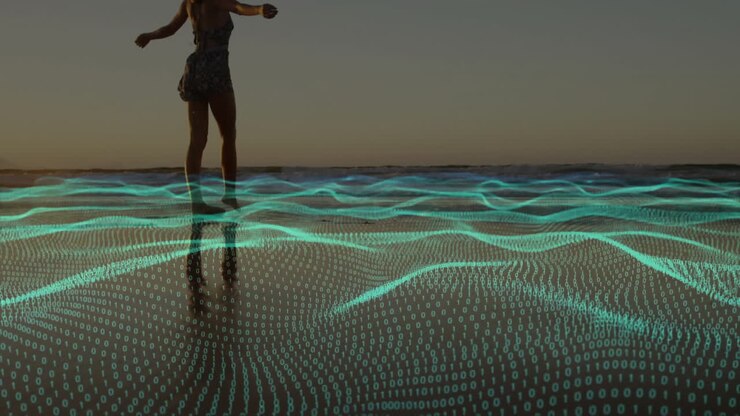 Person walking on beach with digital wave animation overlaying sand