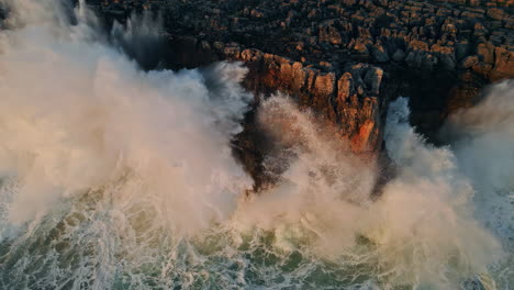 huge ocean splashes crashing high rocks seacoast in slow motion. powerful waves