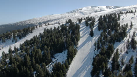 drone shot of snowy peak and ski slope in malyovitsa in bulgaria