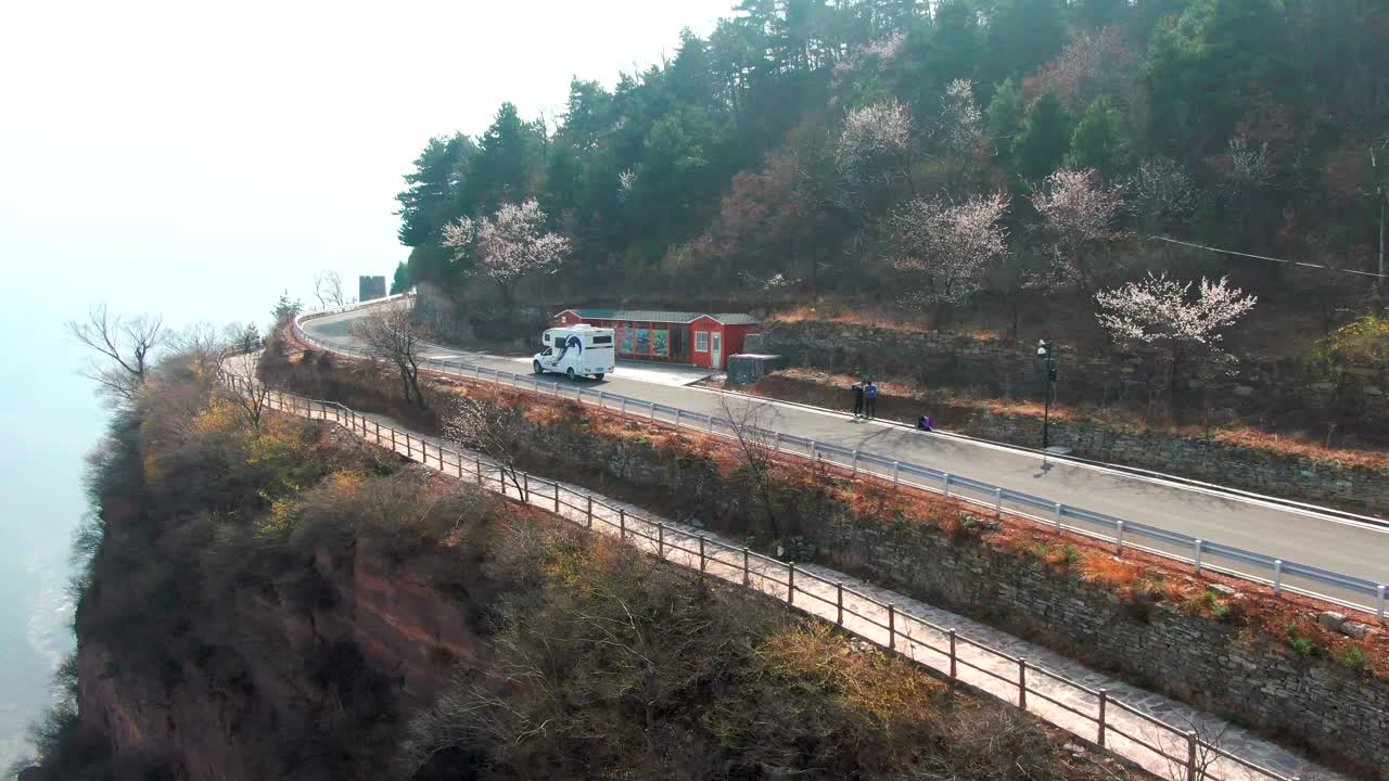 Aerial view of RV driving on dangerous mountain road，The mountain road of precipice
