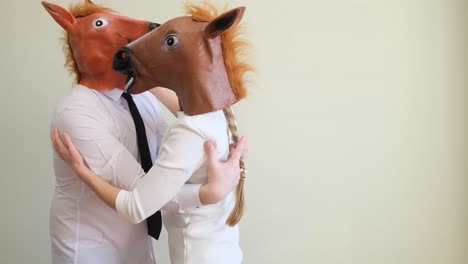 horse mask man and woman dancing at home they hug and look at each other horse mask man and woman dancing at home they hug and look at each other high quality video