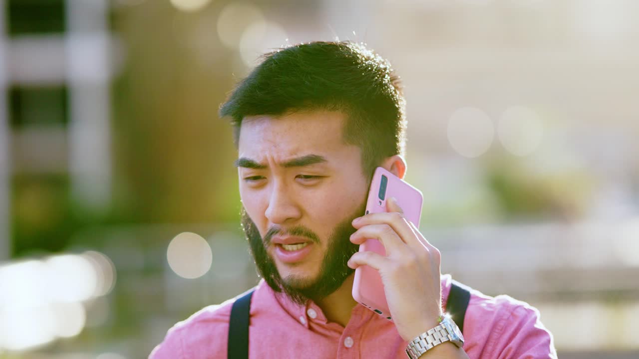 A man talking on a phone outdoors