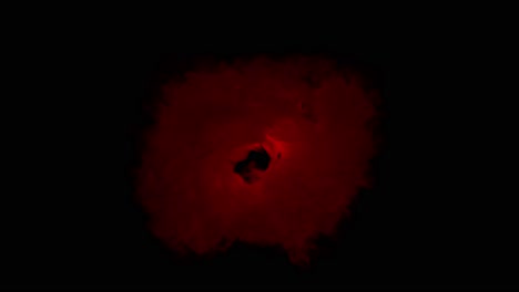 turbulent cloud of smoke or gas pulses with a dramatic red light from its core. looping animation, ideal as an abstract background, angry storm, or energy source