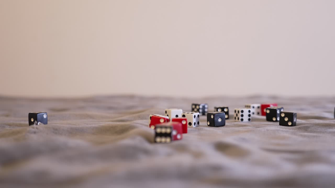 Red dice resting in a pile of black and white dice