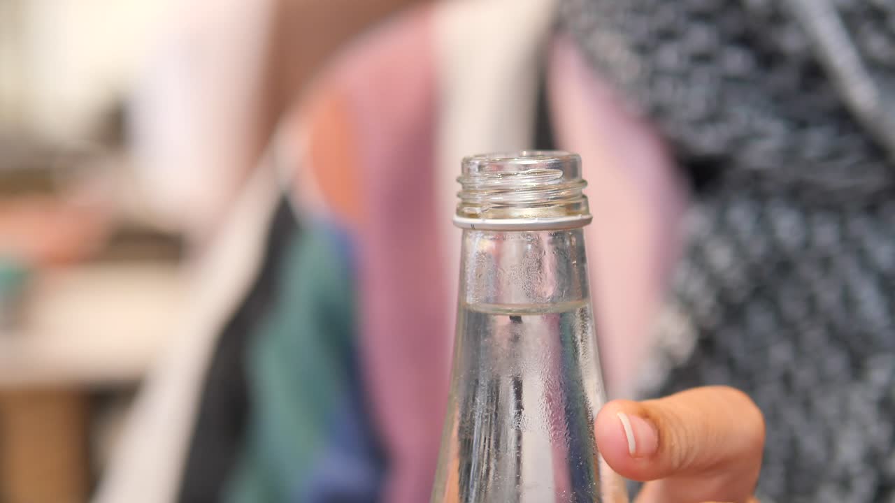 mujer abriendo una botella de agua