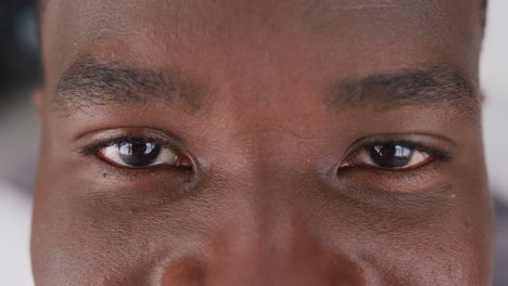 video close up portrait of the eyes of african american man smiling