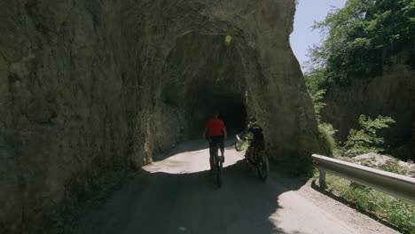 mountain tunnel road with biker