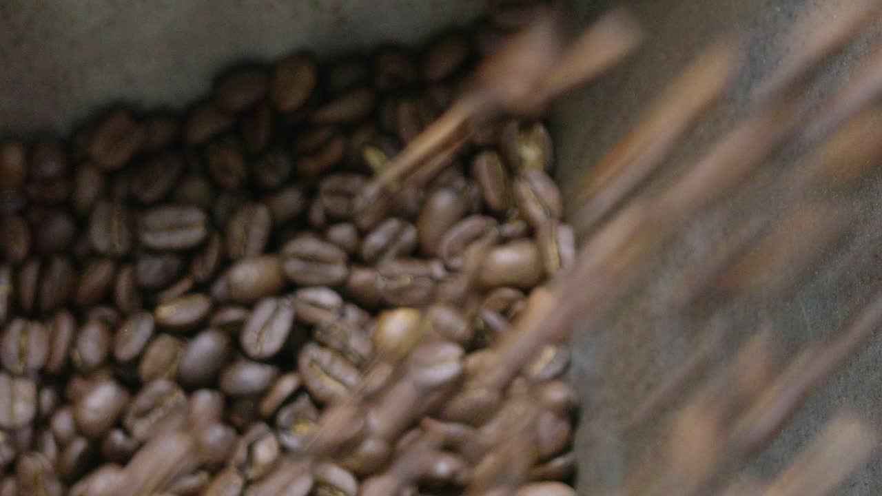 Discover the intricate cozy journey of artisanal coffee bean roasting in a warm workshop setting.