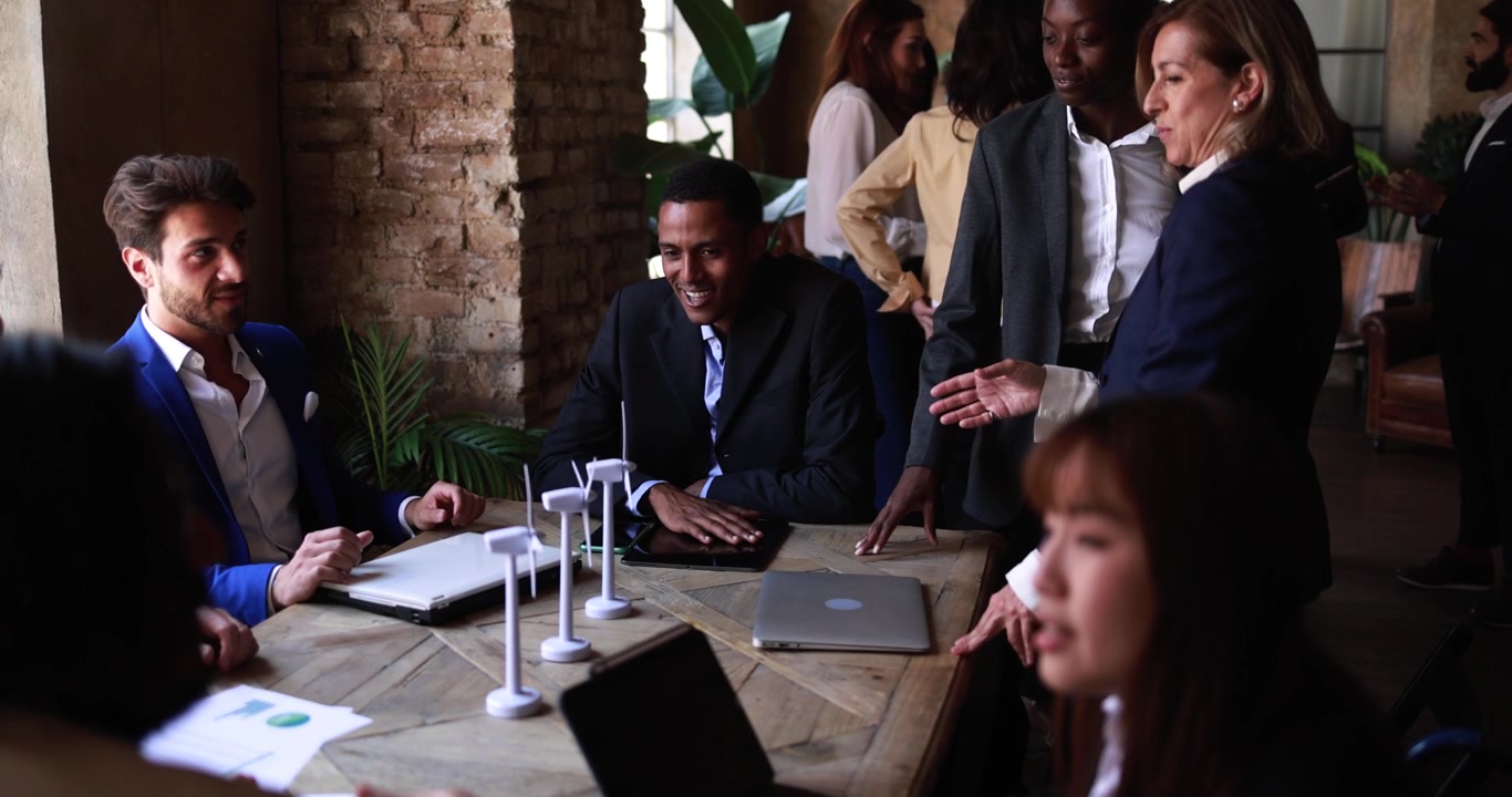 Diverse Business Team Discussing Renewable Energy Project in Office