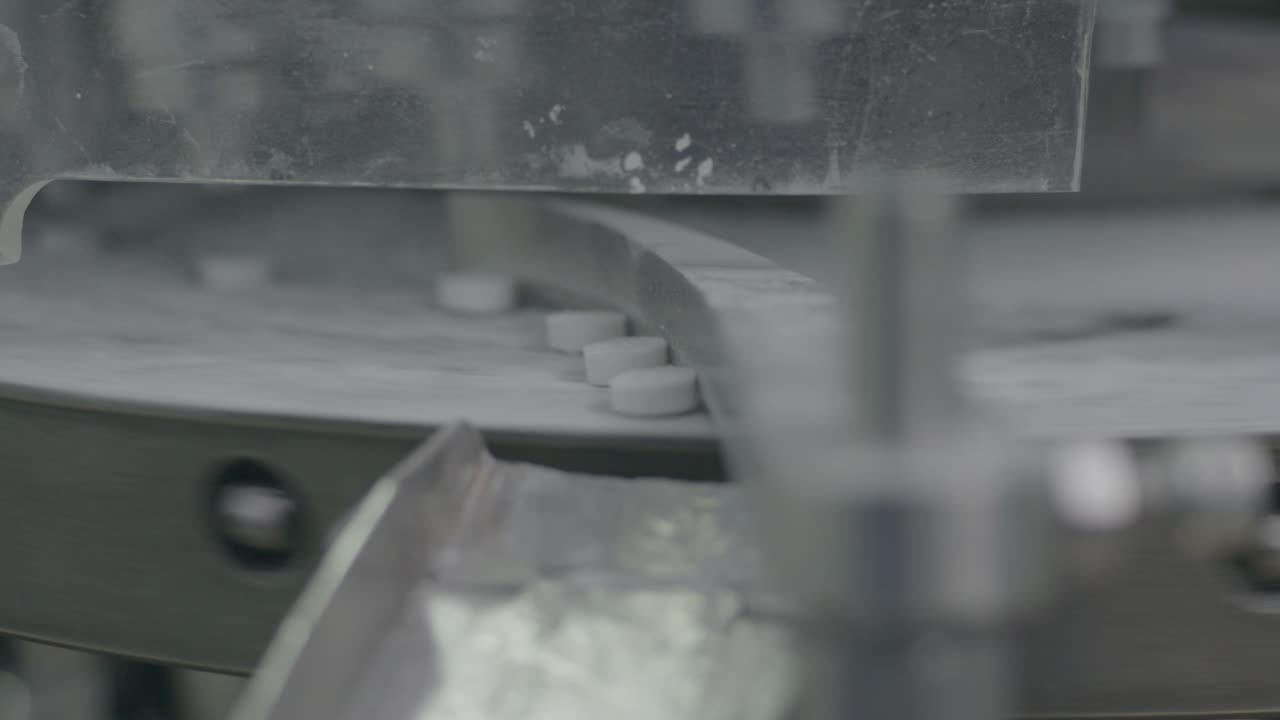 machine that collects and separates aspirins after they have been refined and processed, ensuring quality control.