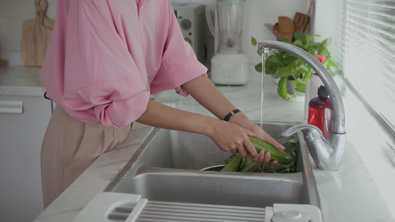 Anonymous Woman Cleaning Vegetables at Kitchen Sink