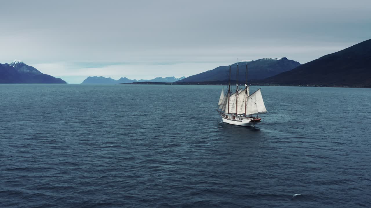 An aerial view of the old sailboat crossing the fjord