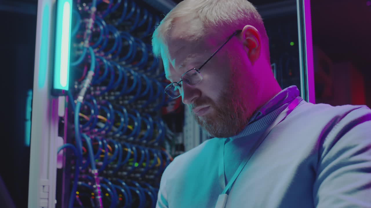 Man working on server racks in a data center