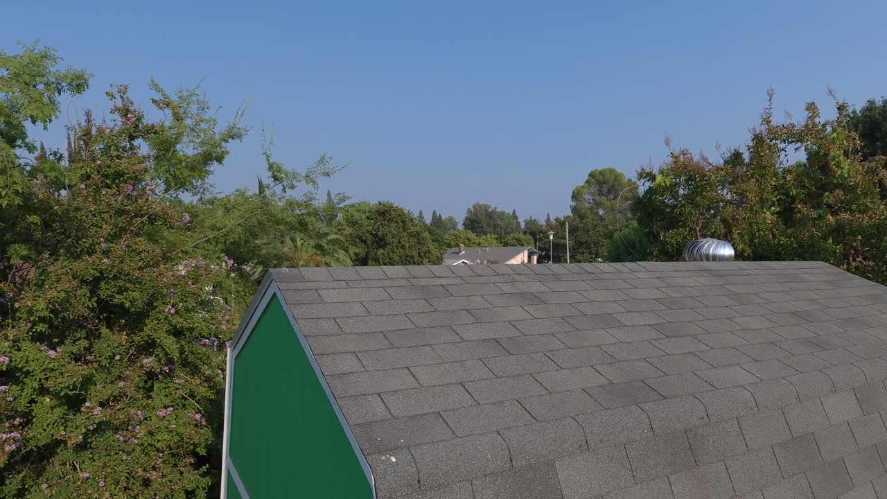 Drone Rise Over Clean Mini Solar Panels on Backyard Shed