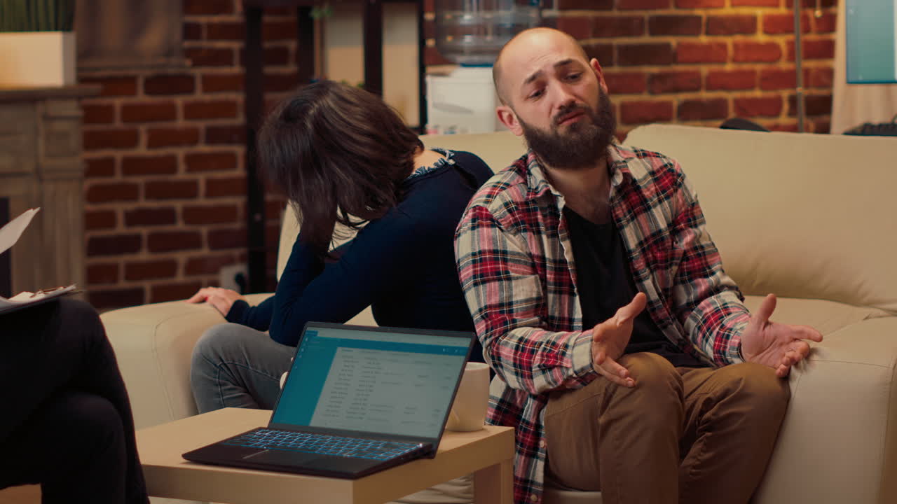 Unhappy couple fighting at counseling session