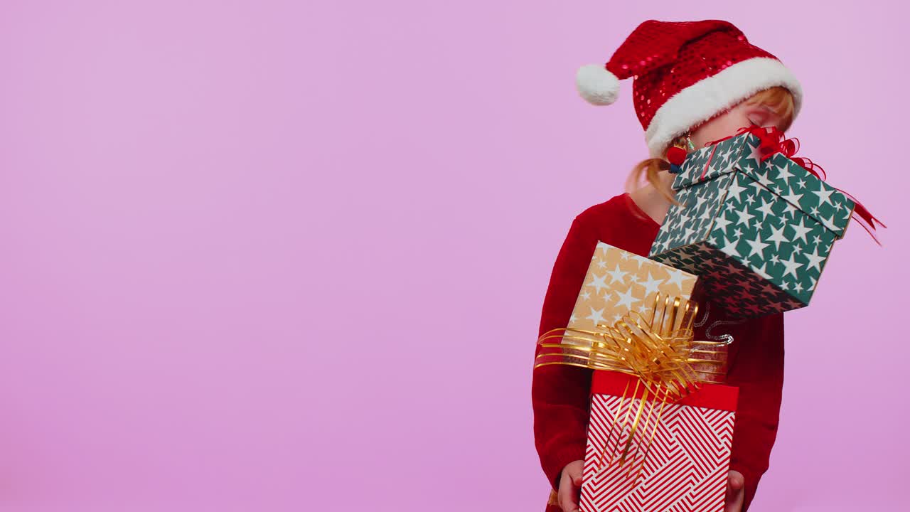 Girl in christmas sweater santa hat smiling holding many gift boxes new year presents shopping