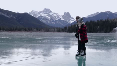 couple skating on a frozen lake