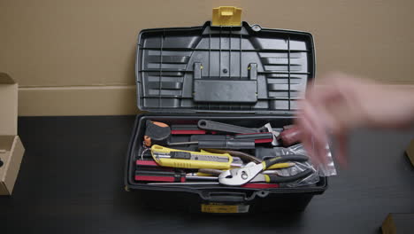 man open a toolbox for work