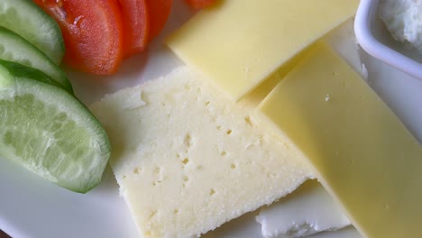 plate of cheese, cucumber, and tomato