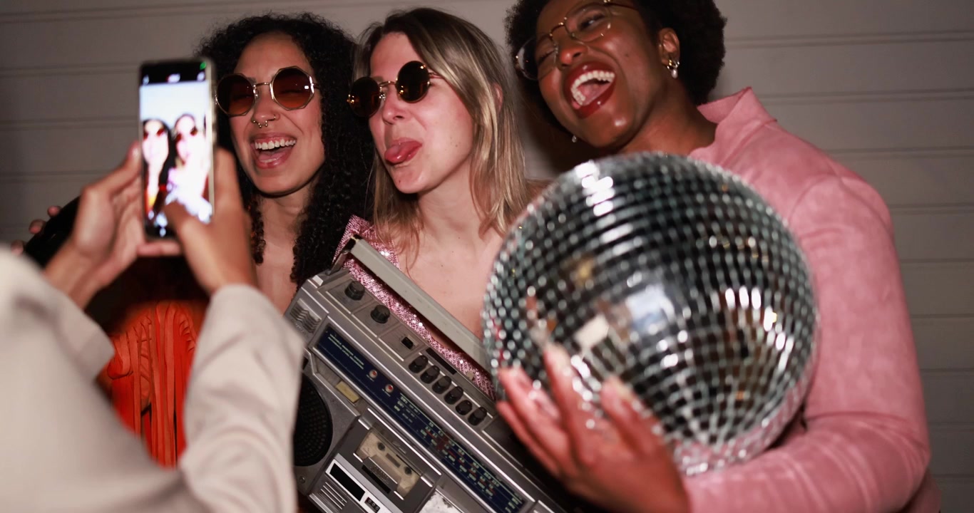 Happy Diverse Women Posing for a Photo with Retro Party Props