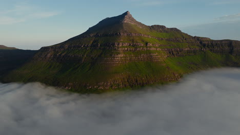 Majestic Mountain Peak Rising Above Clouds