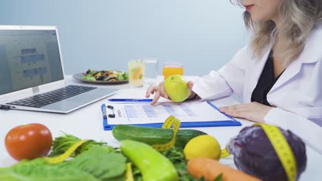 research dietitian. examines vegetables and takes notes.