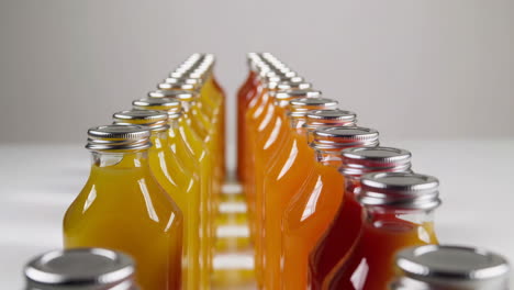 rows of colorful juice bottles with different hues
