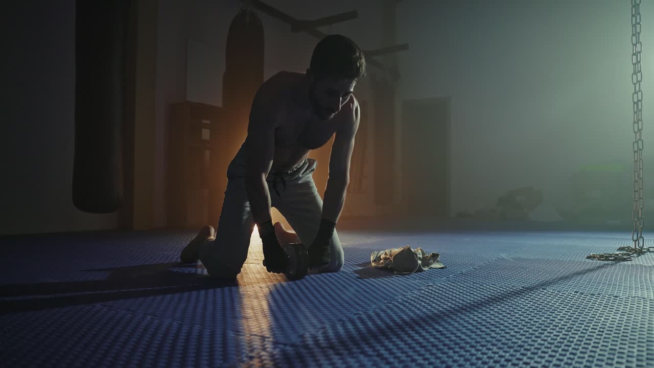 Man performing wrist exercise in a gym
