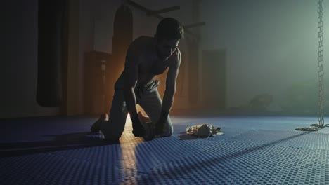man performing wrist exercise in a gym