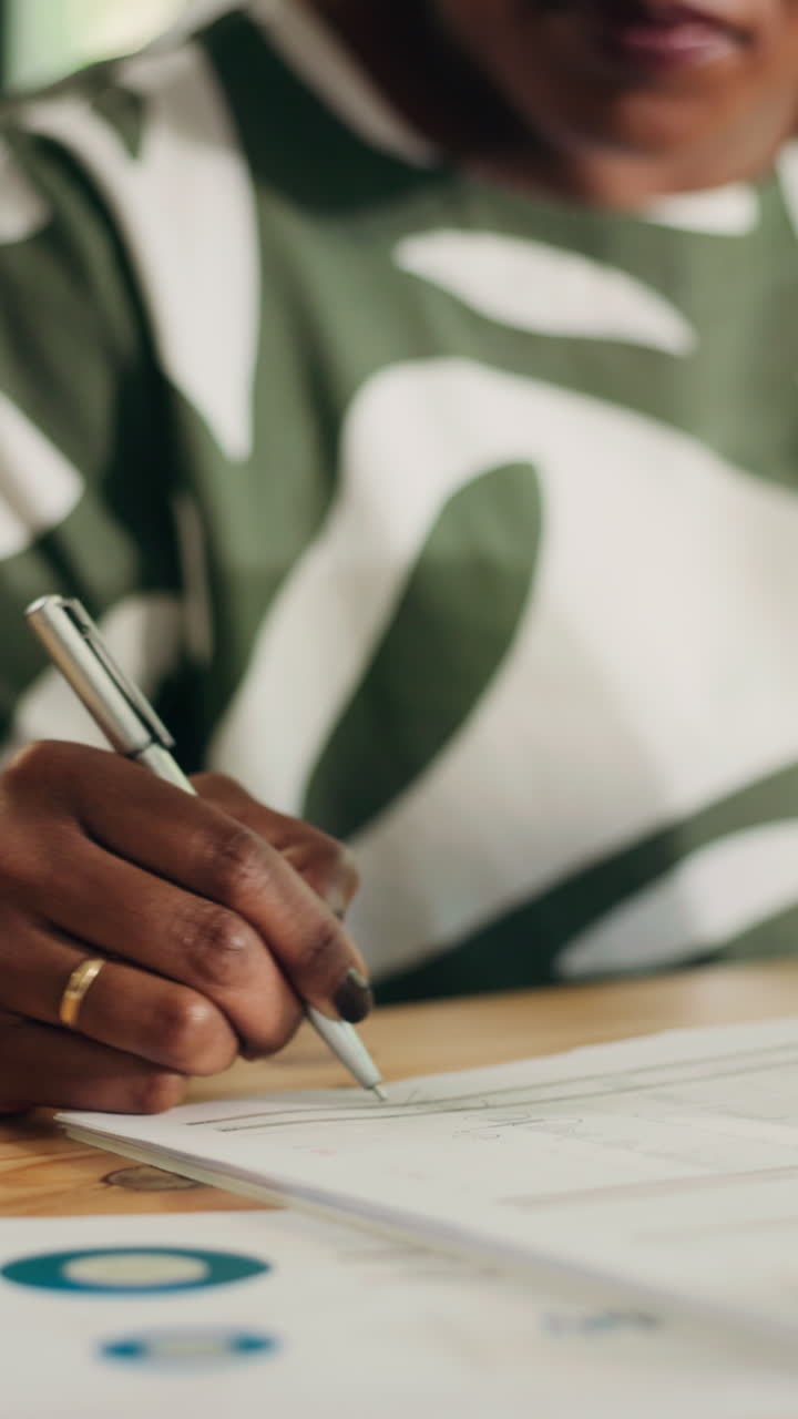 Close-up of a Person's Hand Writing on a Document with a Pen