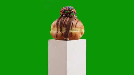 chocolate ball sprinkles jelly doughnut, sufganiyah doughnut meets a fun, sprinkle-loaded truffle for a unique dessert shot on chroma key or green screen