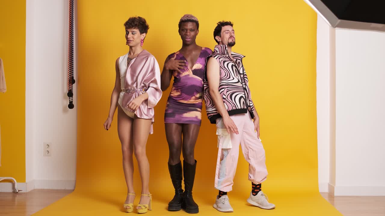 Happy multiethnic transgender men dancing and having fun