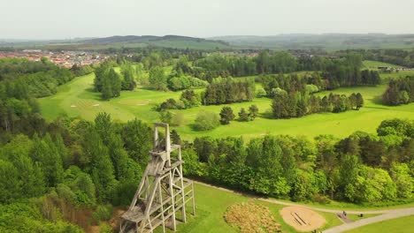 aerial pan around monument in lochore meadows to reveal golf course behind