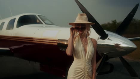 woman in a stylish dress near a private jet