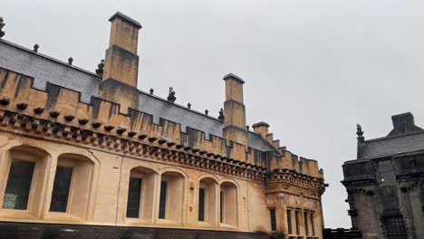 close panning shot of the beautiful sandstone buildings at the courtyard of stirling castle